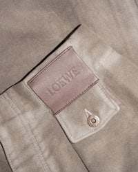 a close up of a brown leather jacket with a label on it